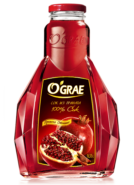 Граненая стеклянная бутылка гранатового сока OGRAE 100% с красной крышкой. На этикетке, созданной Soldis, изображен гранат и текст на русском языке, указывающий на то, что продукт представляет собой 100% сок объемом 0,33 л.